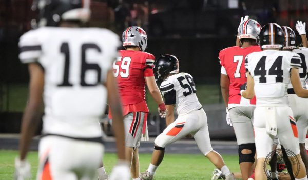 Colden Bray (#58), celebrates after making a stuff in the backfield during Ames High's "Little CyHawk" bout vs. City High.