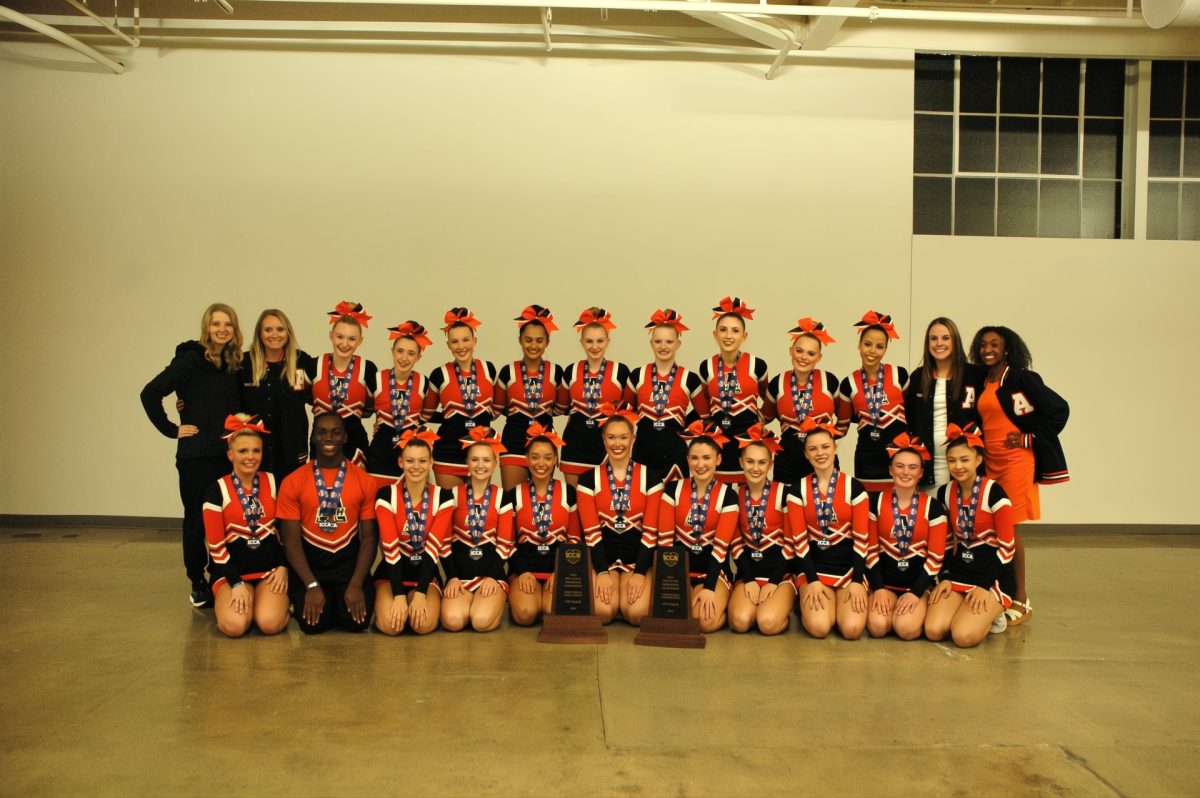 State competition group poses for a picture after their victory at state cheer.   Photo by Ethel Navarro